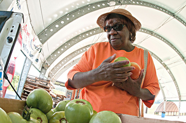 A shopper eyes heirloom tomatoes at a Kentucky farmers' market.