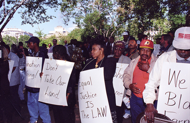 Black farmers protest across from the White House on September 22, 1997. Protesters alleged that USDA denied black farmers equal access to farm loans and assistance based on their race. North Carolina farmer Timothy Pigford and 400 other black farmers filed the Pigford v. Glickman (Pigford I) class-action lawsuit against USDA in 1997; USDA settled Pigford I in 1999. Photo credit: USDA, Anson Eaglin.
