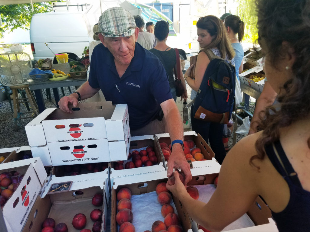 NSAC staff buying fresh fruit at Tonnemaker Farmstand. Photo credit: Reana Kovalcik.