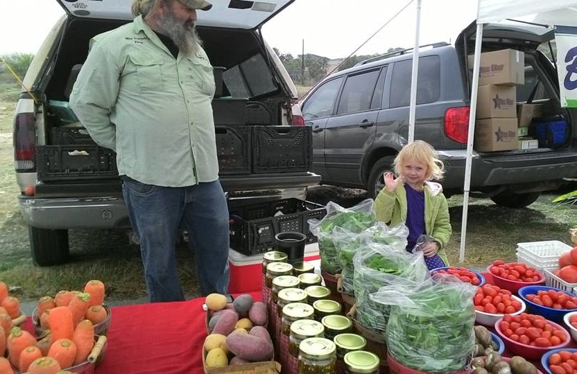 Anthony Micheli and daughter Scarlett stand ready to sell their vegetables at a Texas Farmers Market. Photo credit: USDA.
